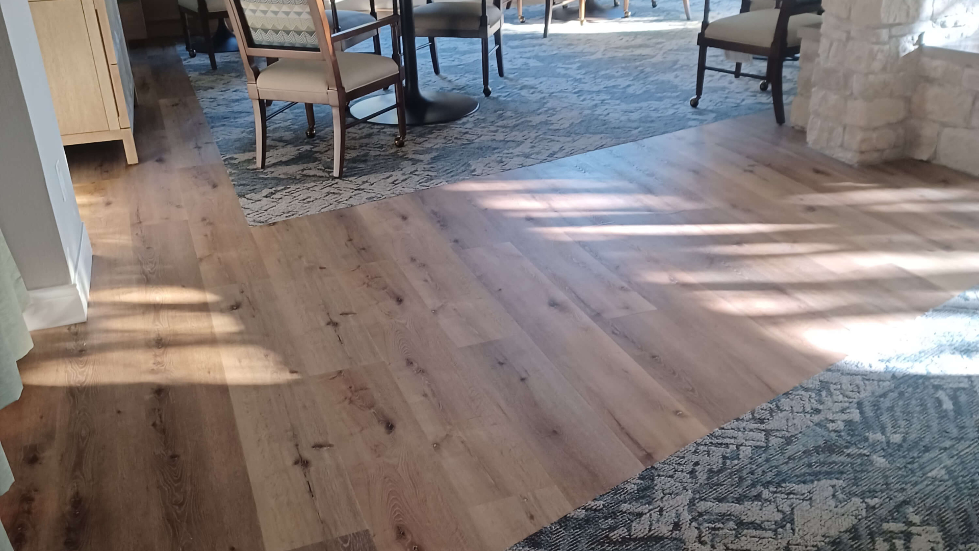 matching blue area rugs in a dining room and living room